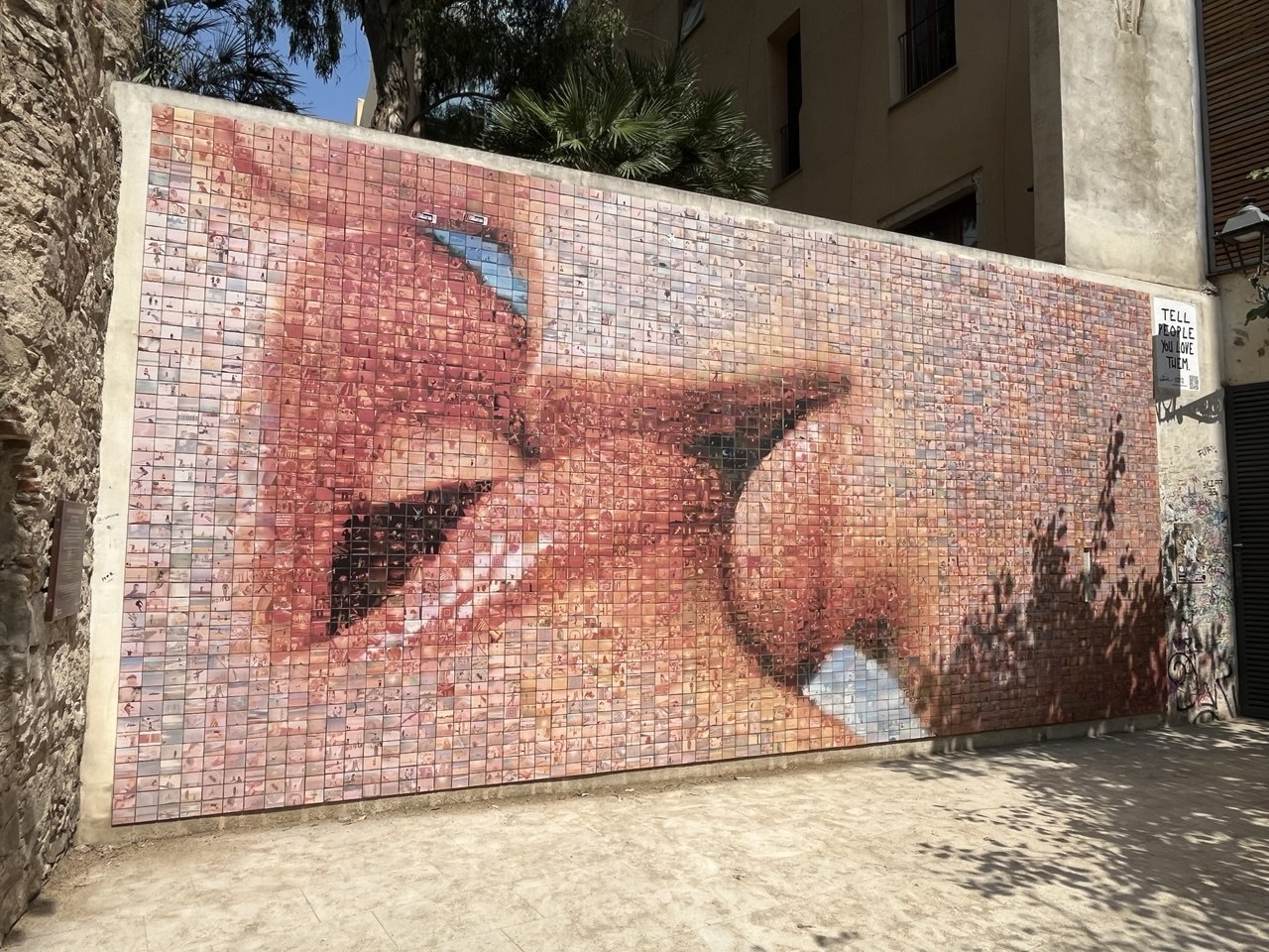 Mosaic mural of a kiss made of thousands of small photos